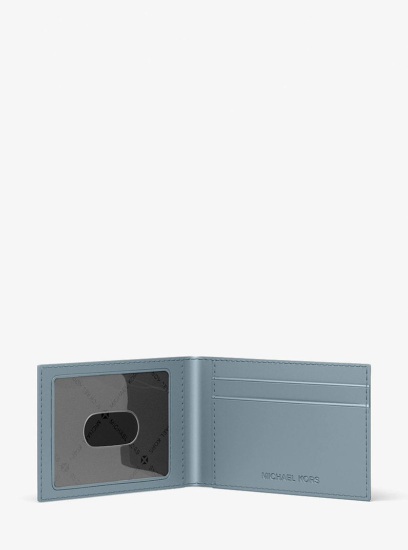 Michael Kors Cooper Logo Debossed Billfold Wallet With Passcase Pale Ocean in Pale Ocean – Close-up Logo Detail