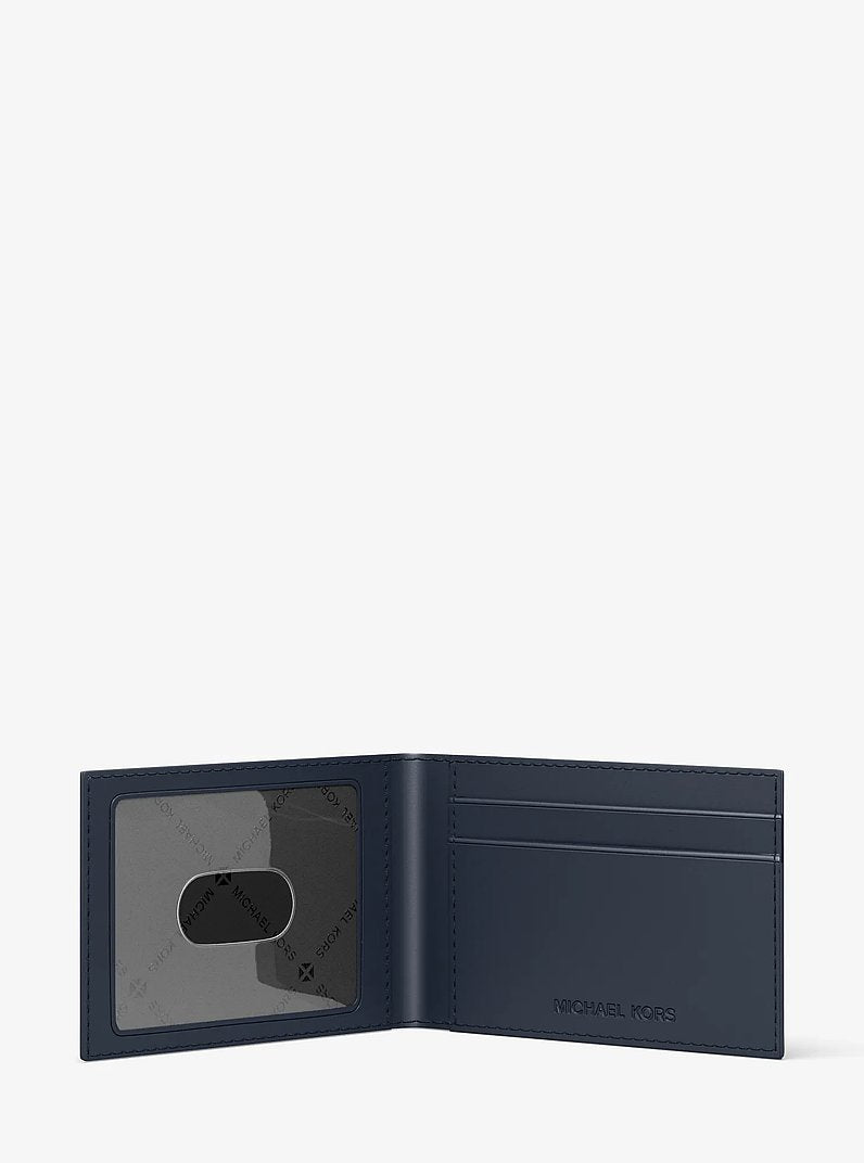 Michael Kors Cooper Logo Debossed Billfold Wallet With Passcase Navy in Navy – Close-up Logo Detail