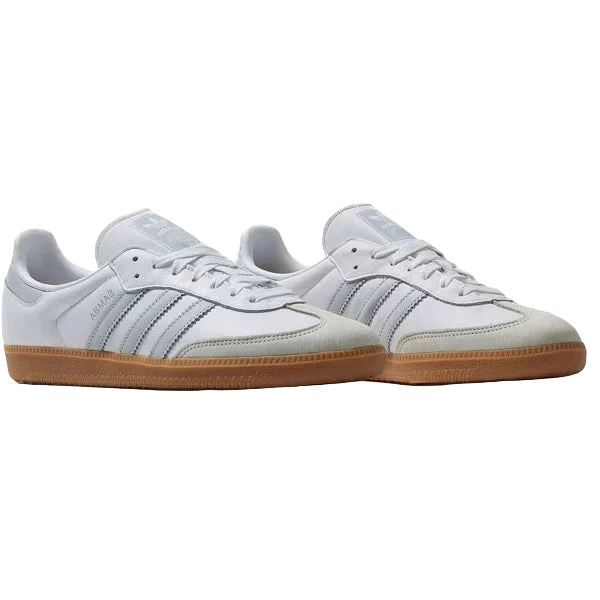 White sneakers with brown soles on a light gray background