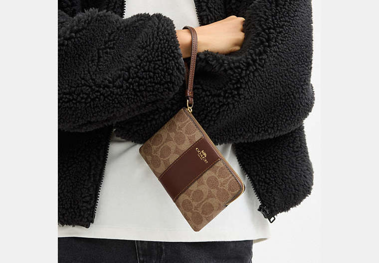 Coach Corner Zip Wristlet In Signature Canvas With Stripe Tan/Brown in striped - Front View | Authentic Coach Luxury Accessories